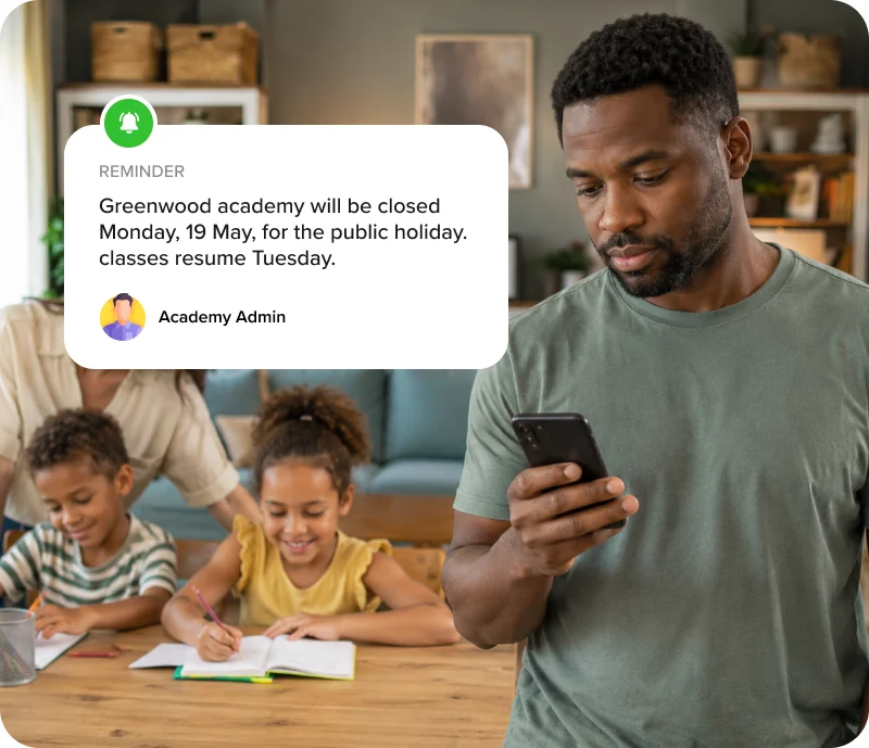 Parent checking a WhatsApp school announcement while children do homework nearby.